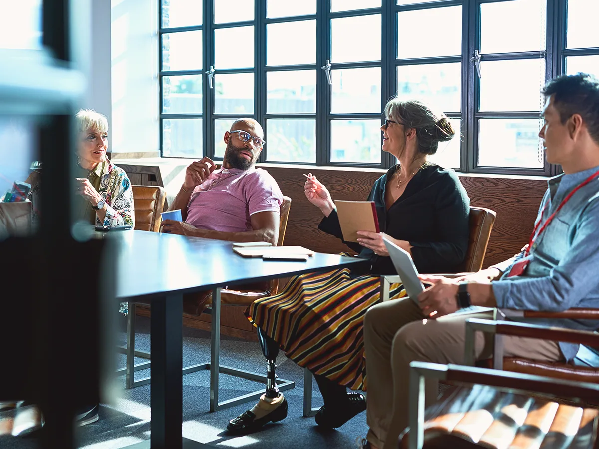 What is the Americans with Disabilities Act?, group of coworkers talking around a conference table